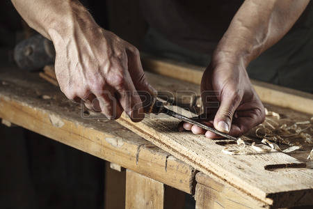 45514539-closeup-of-a-carpenter-hands-working-with-a-chisel-and-carving-tools-on-wooden-workbench.jpg